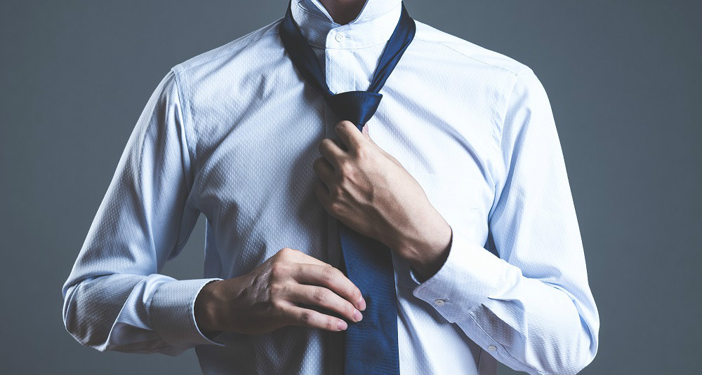 出張に向かおうとネクタイを締める男性